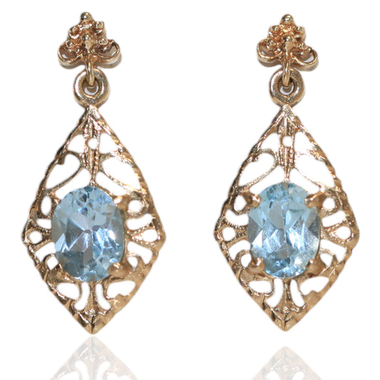 Vintage 14K gold filigree drop earrings with oval aquamarine gemstones on a white background