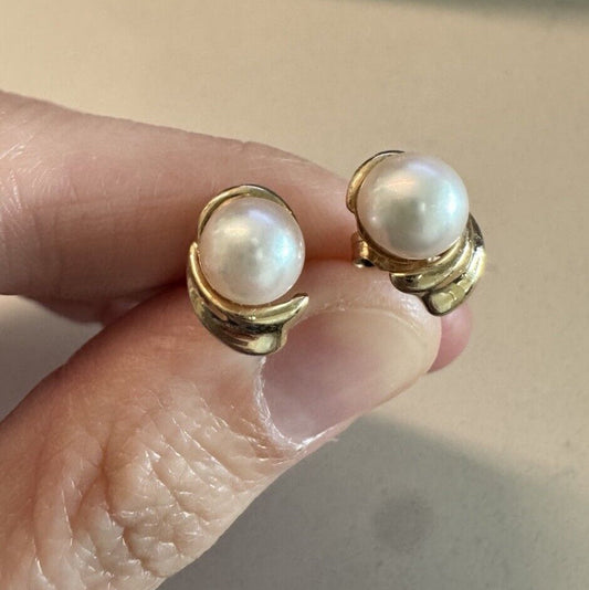 Front view of vintage round pearl stud earrings in 14K yellow gold