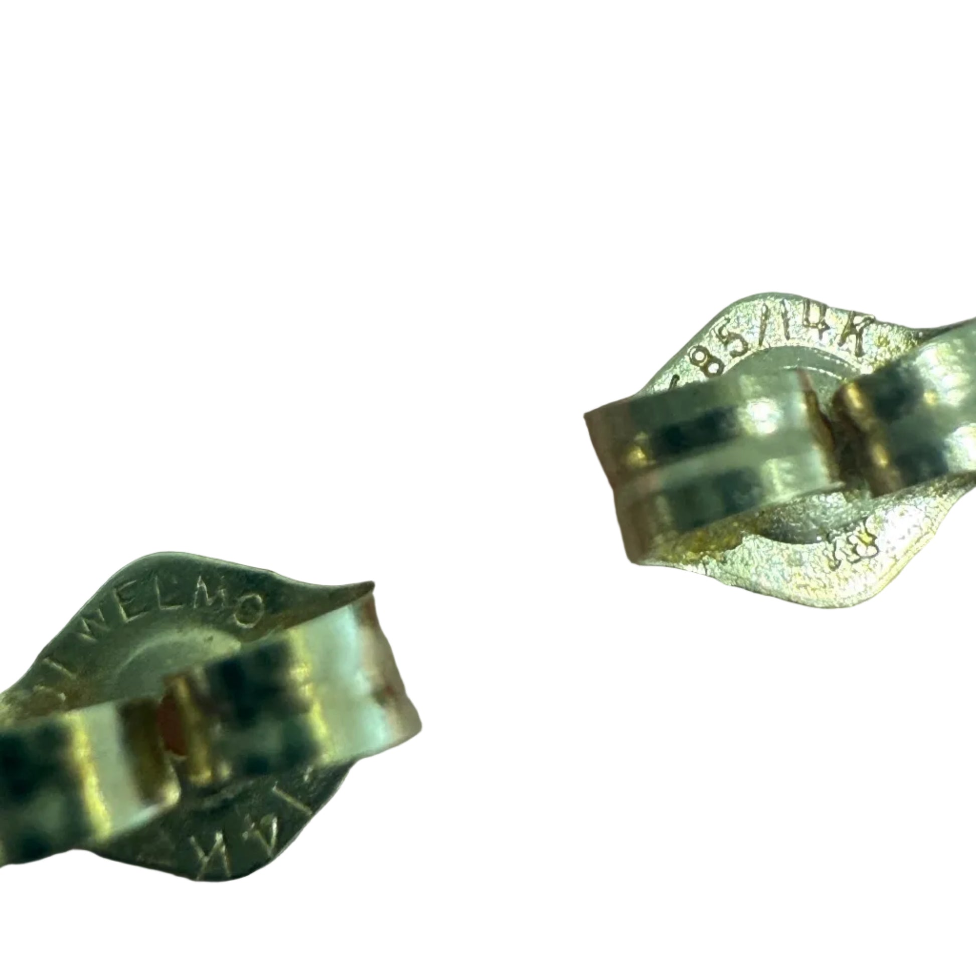 Close-up of the 14K gold stamp and maker’s mark on the backs of vintage filigree earrings