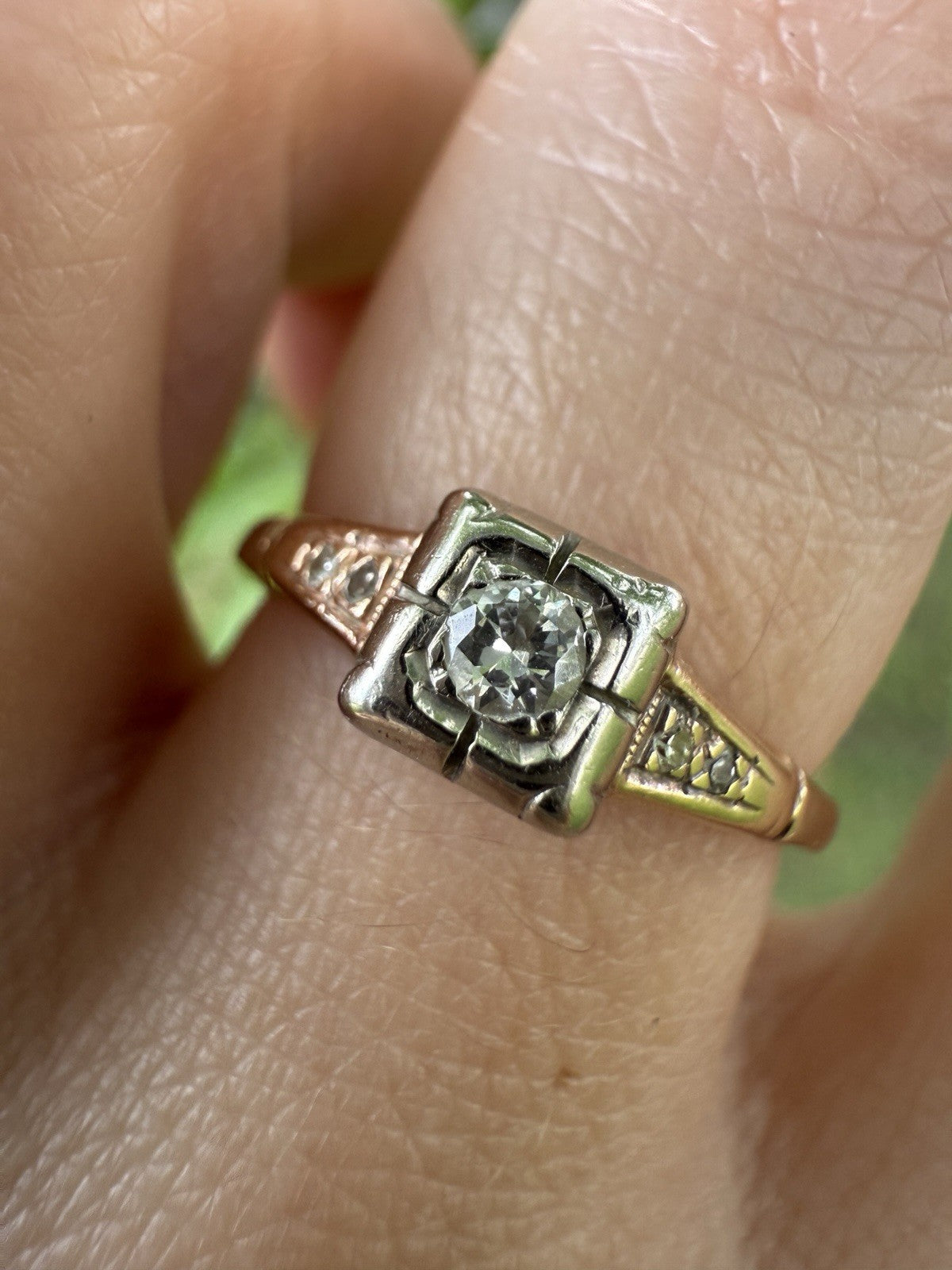 Close-up of 1930s Art Deco ArtCarved 14K two-tone diamond ring with old European cut center stone and illusion head setting