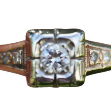 Close-up of 1930s Art Deco ArtCarved 14K two-tone diamond ring with old European cut center and illusion head setting

