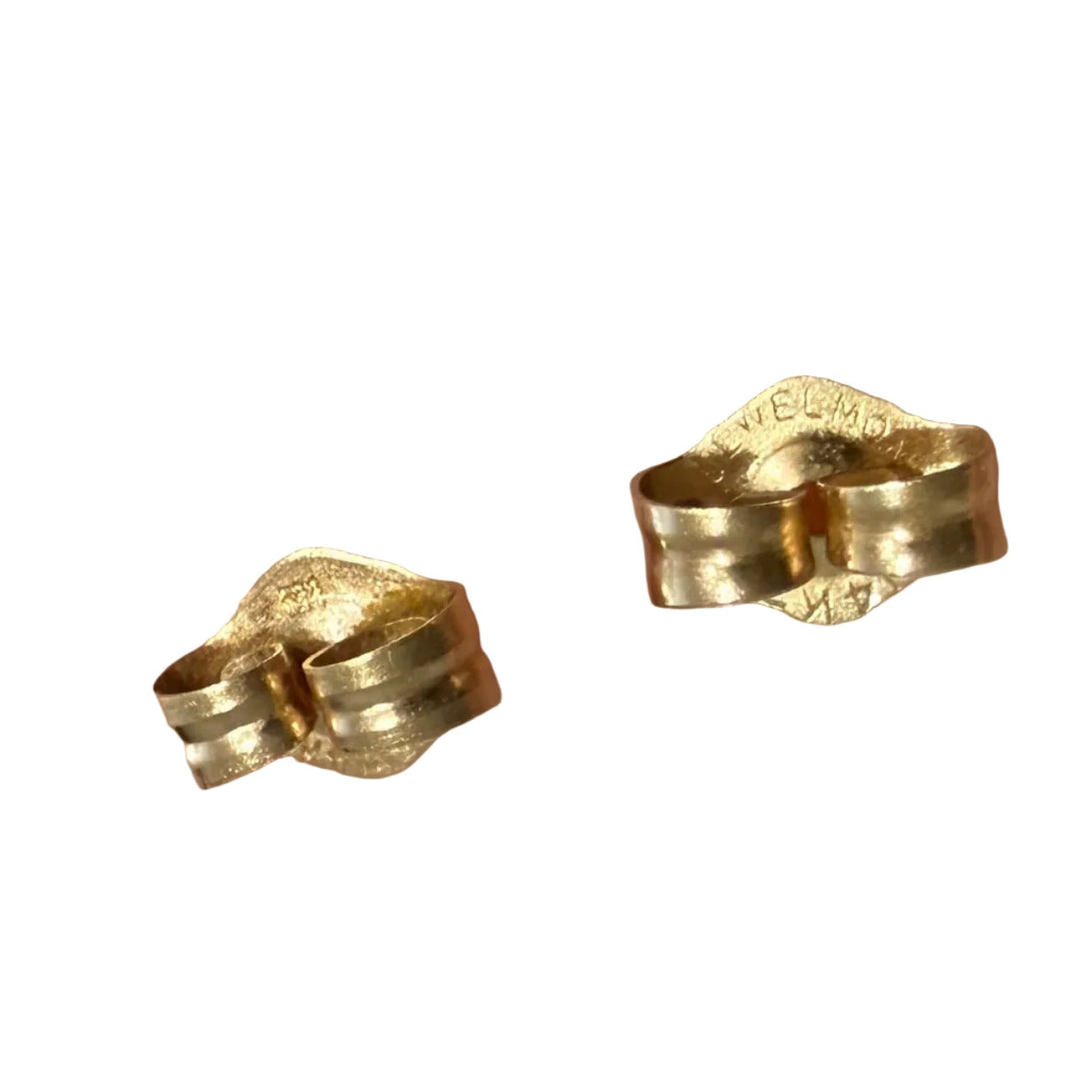 Close-up of 14K gold earring backs showing stamped markings on a white background