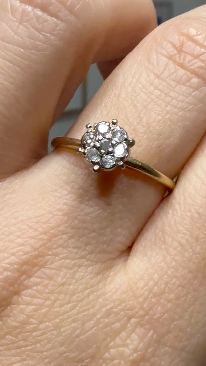 Video of 1950s vintage 10K two-tone gold engagement ring with seven diamond floral cluster, shown on hand in natural light to display sparkle