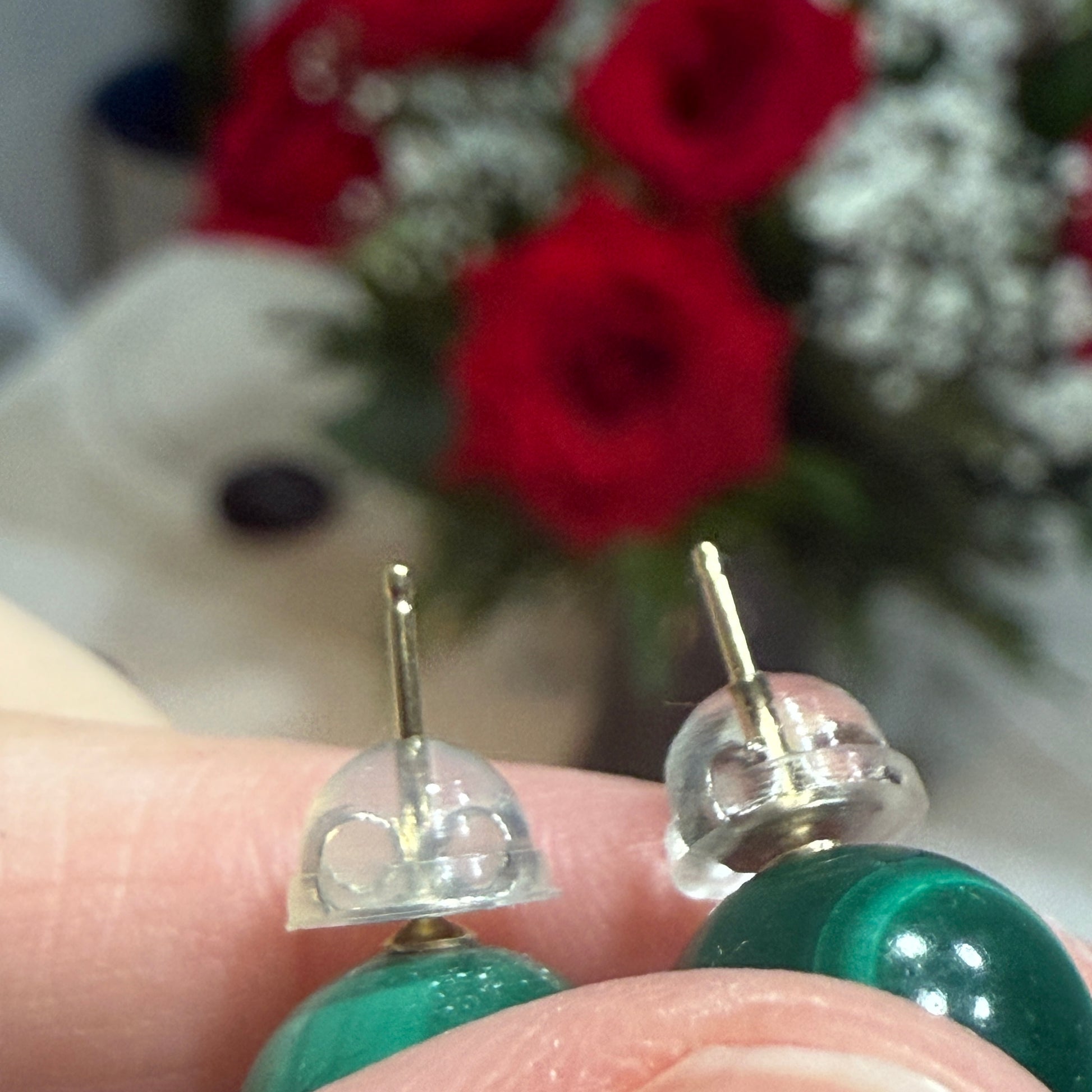 Close-up of 14K gold earring posts with new sterling silver silicone backs on malachite studs