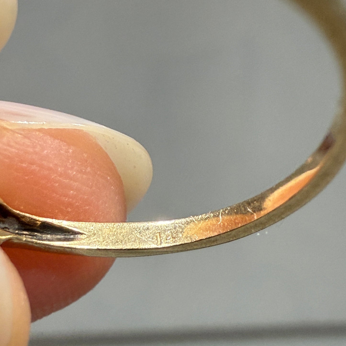 Close-up of faint 14K gold hallmark inside 1940s vintage two-tone diamond engagement ring band.