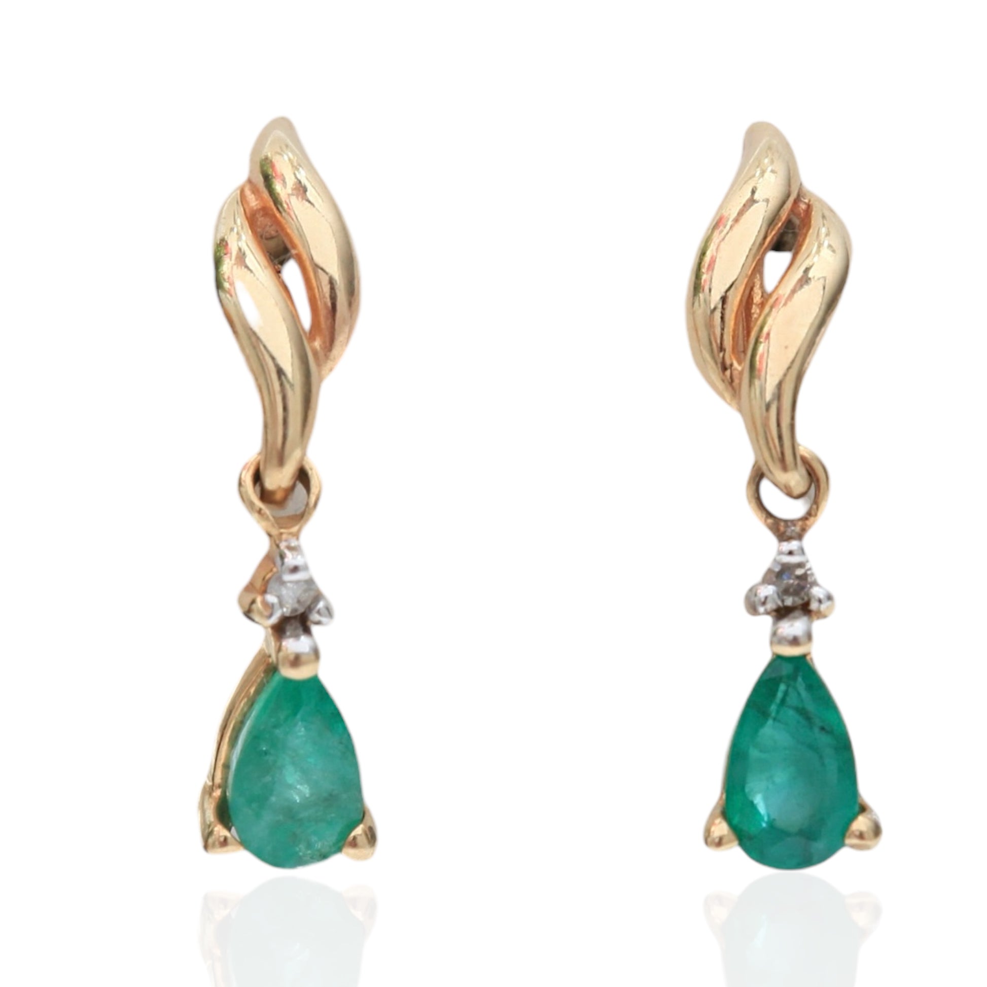 Pair of 1990s vintage 10K yellow gold dangle earrings with teardrop emeralds and diamond accents on white background