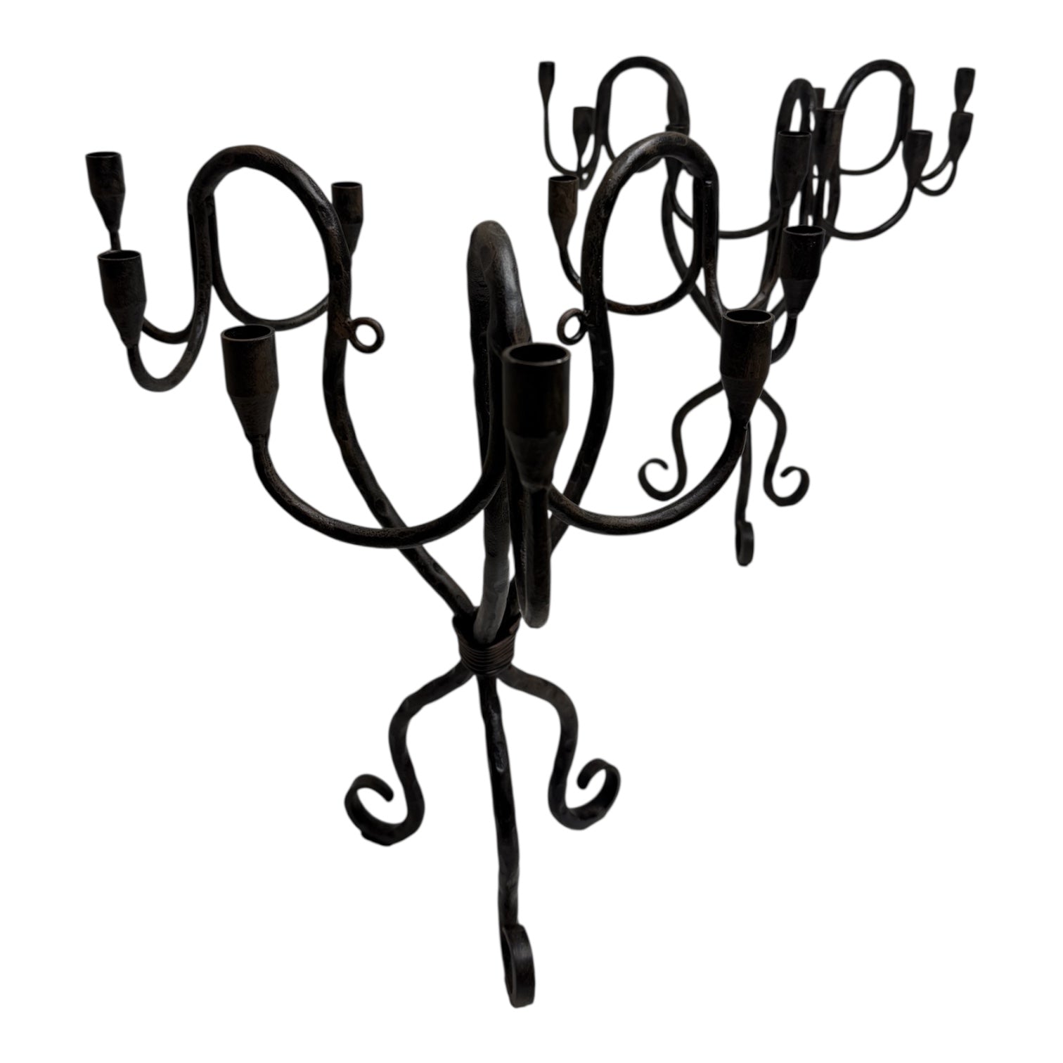 Vintage hand-wrought iron candelabra with scrolling forged arms and dark patina, photographed on a white background.