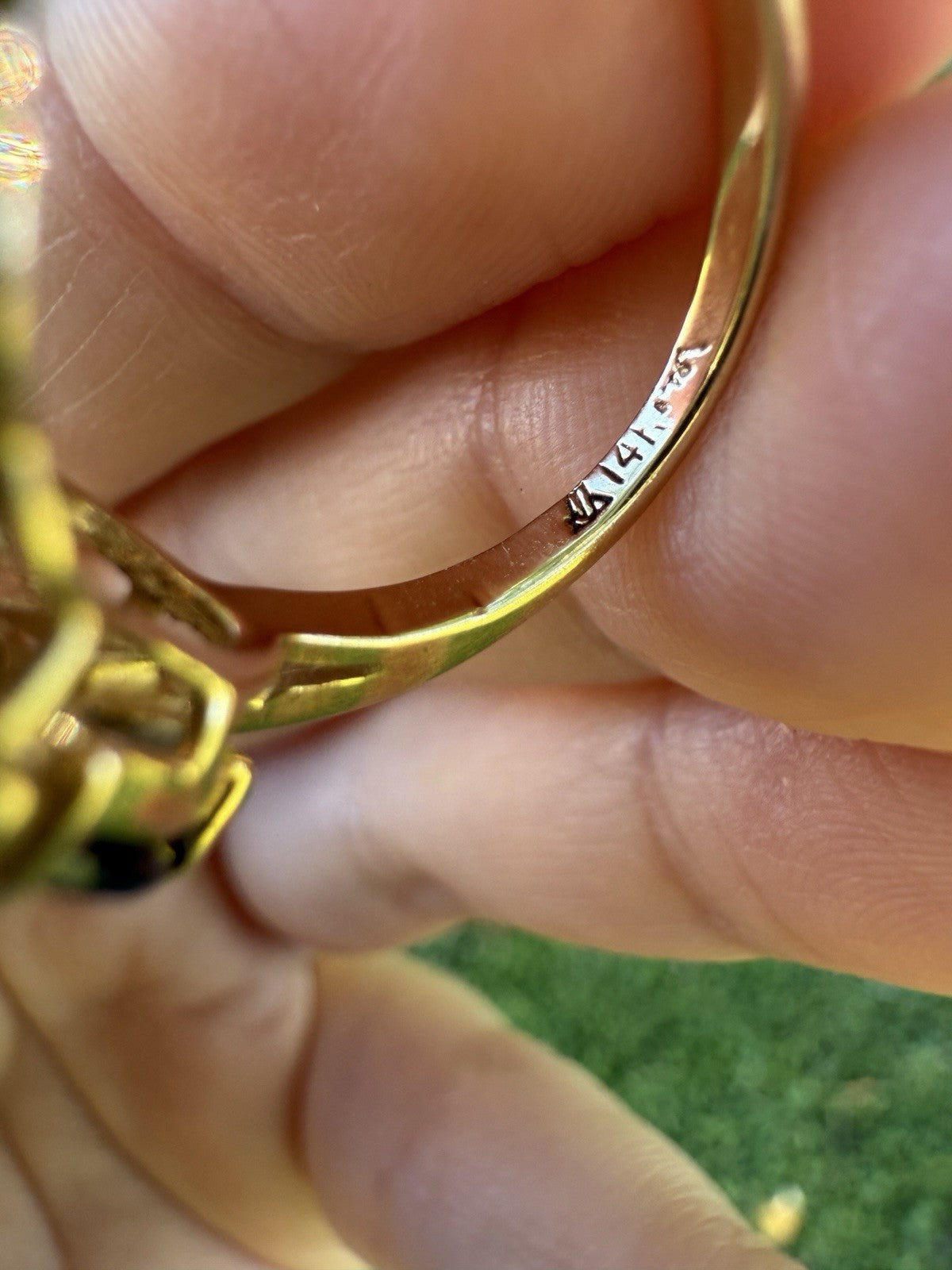 Inside band of vintage 1960s 14K gold sapphire and diamond swirl bypass ring showing 14K hallmark stamp.