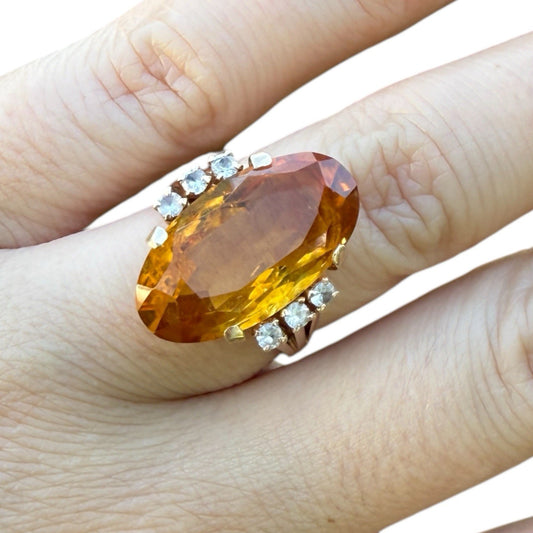 1950s mid-century 14K gold cocktail ring with large oval citrine and diamond accents on finger