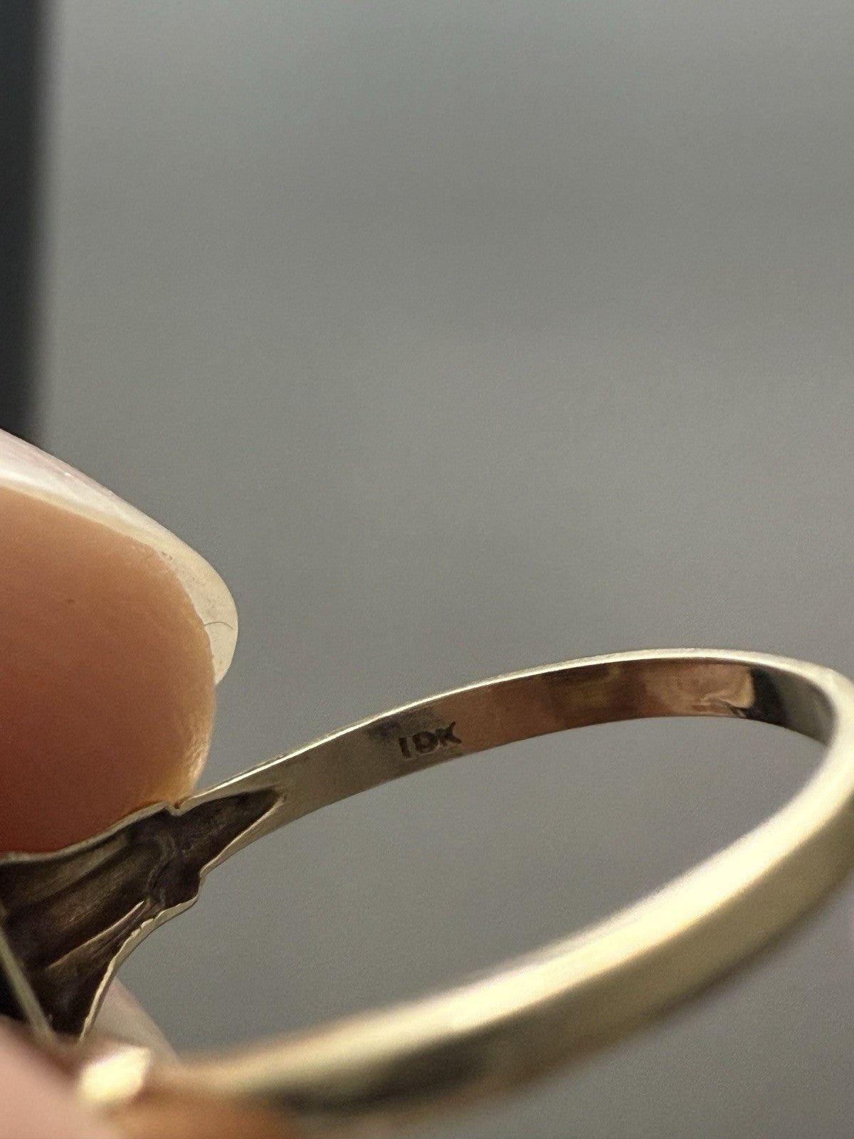 Close-up of the inner band of a 10K yellow gold vintage ring showing the 10K hallmark stamp.