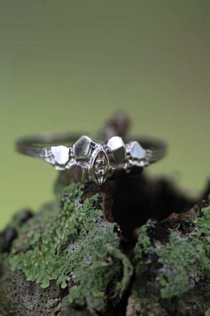 1950s vintage 10K white gold twig band illusion marquise diamond ring on moss background, size 5.75