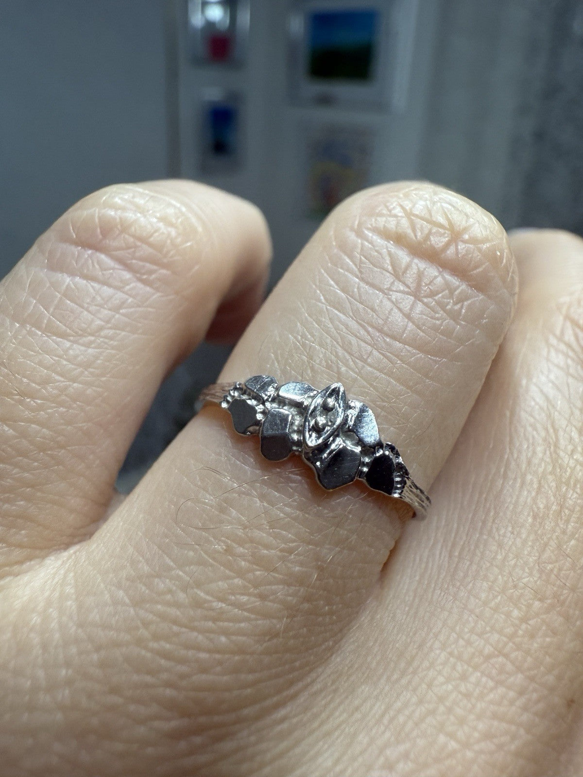1950s vintage 10K white gold illusion marquise diamond ring with twig-textured band on finger, size 5.75