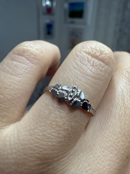 1950s vintage 10K white gold illusion marquise diamond ring with twig-textured band on finger, size 5.75