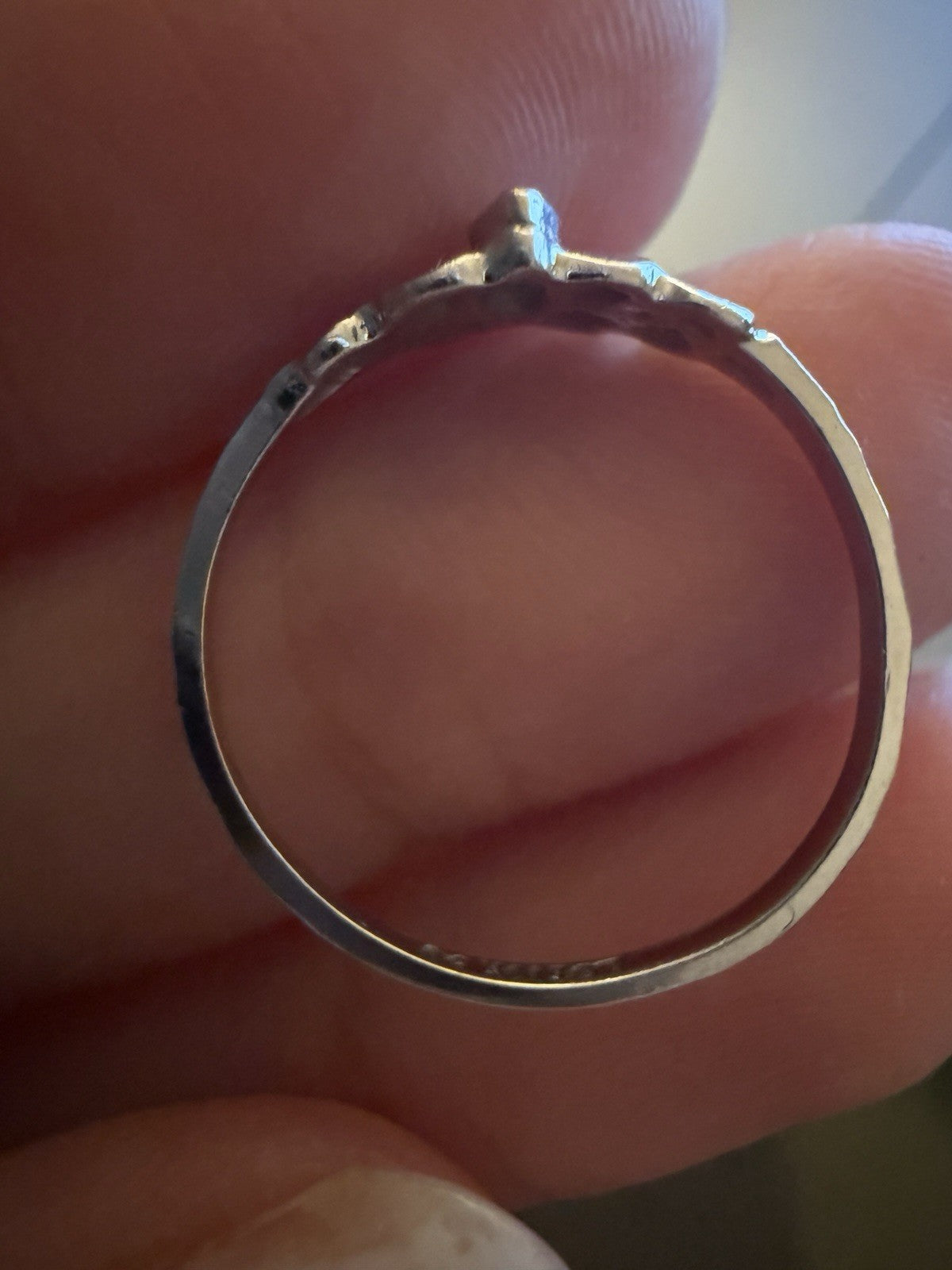 1950s vintage 10K white gold twig band illusion marquise diamond ring held between fingers showing sturdy circular band, size 5.75