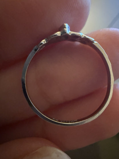 1950s vintage 10K white gold twig band illusion marquise diamond ring held between fingers showing sturdy circular band, size 5.75