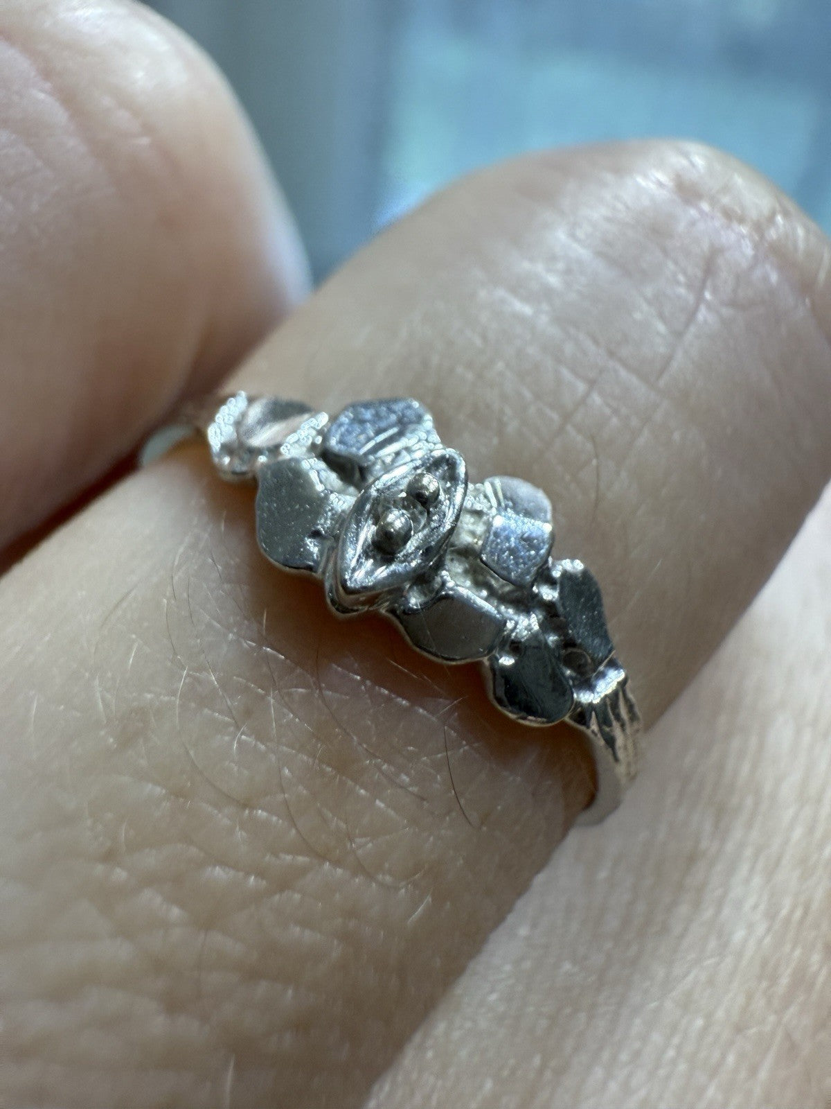 Close-up of 1950s vintage 10K white gold illusion marquise diamond twig band ring on hand, size 5.75