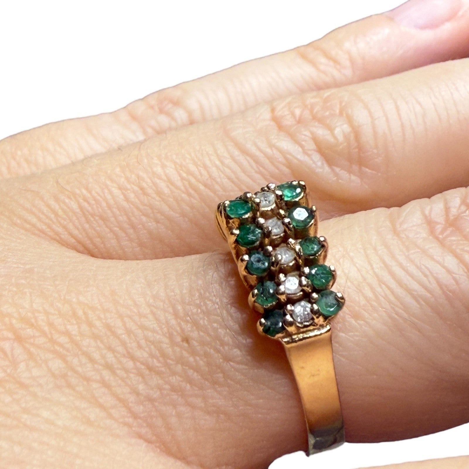 Close-up of vintage 14K yellow gold emerald and diamond pyramid cocktail ring worn on finger, size 5.75