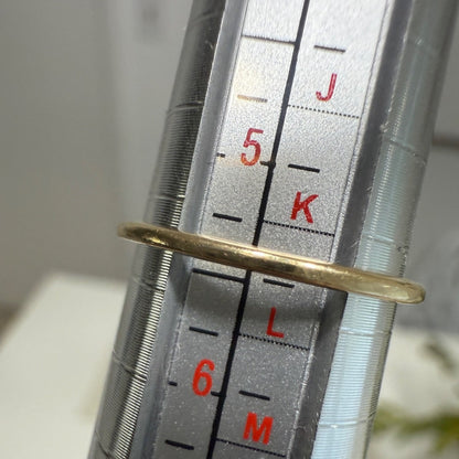 Vintage 1950s 10K gold diamond illusion cluster ring measured on a ring mandrel, showing size slightly over 5.25, closer to 5.375.