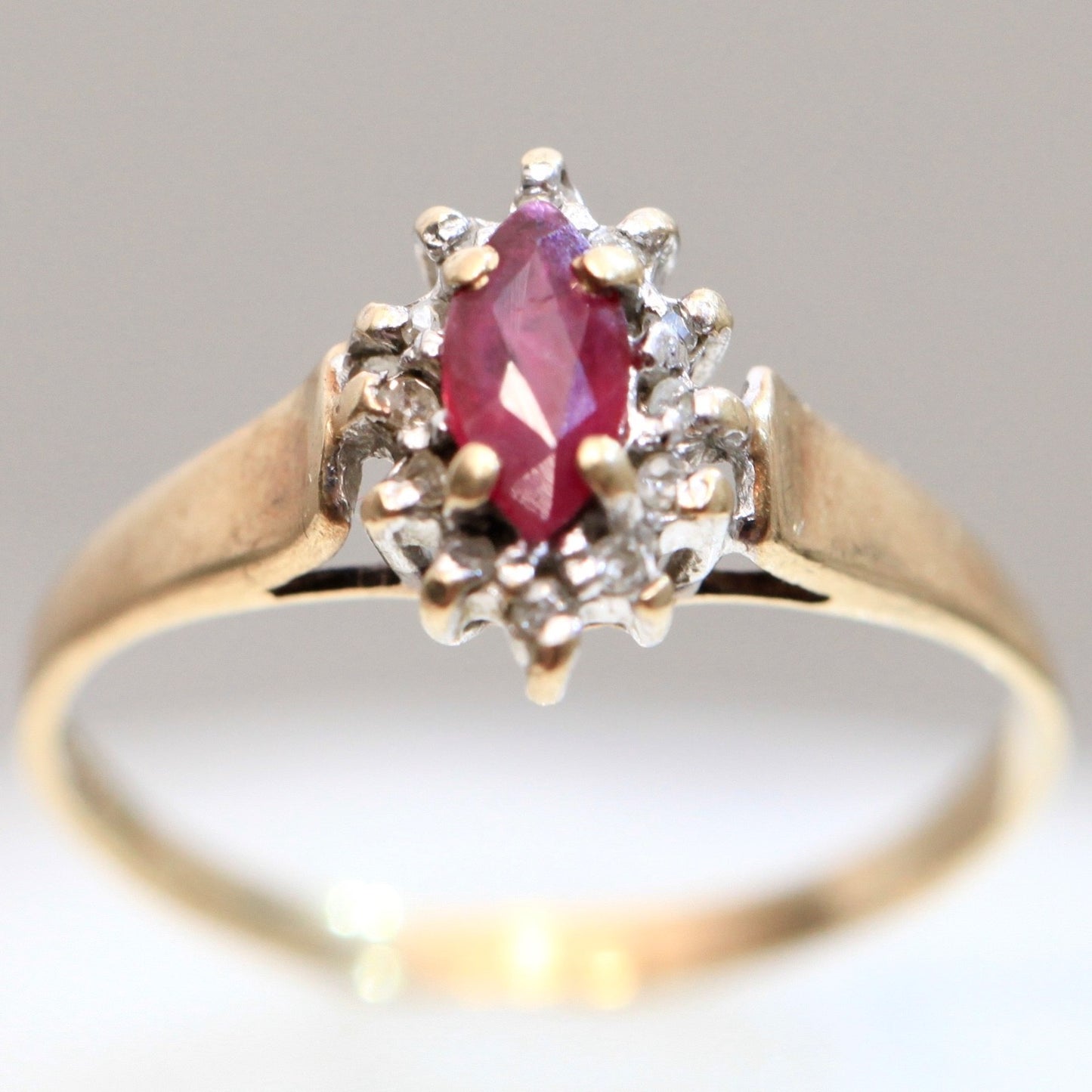 1970s vintage 10K gold ruby and diamond halo ring, marquise cut ruby, size 5.75