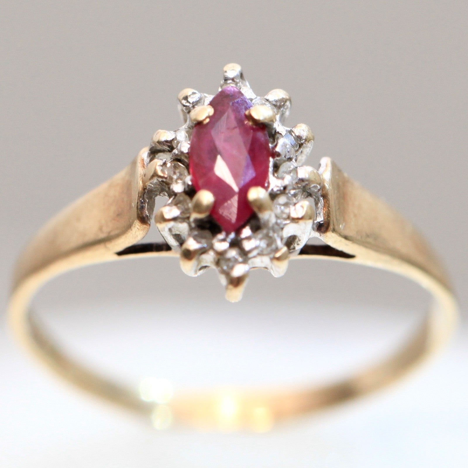 1970s vintage 10K gold ruby and diamond halo ring, marquise cut ruby, size 5.75