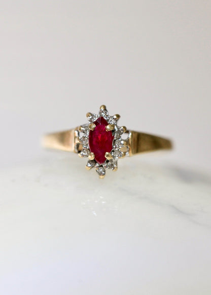 1970s vintage 10K gold ruby and diamond halo ring, marquise cut ruby, size 5.75, photographed on white background
