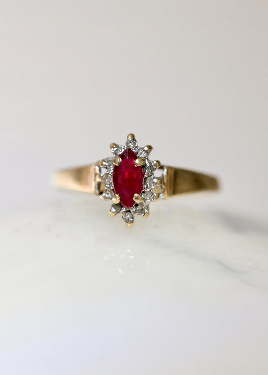 1970s vintage 10K gold ruby and diamond halo ring, marquise cut ruby, size 5.75, photographed on white background