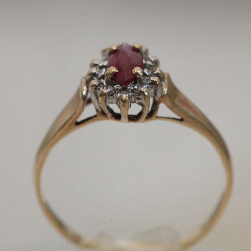 1970s vintage 10K gold ruby and diamond halo ring, marquise cut ruby with raised prong setting and open gallery design