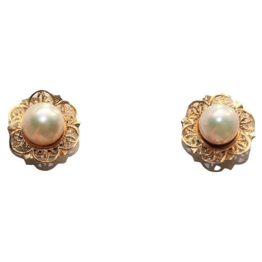 Back view of vintage 14K gold pearl stud earrings showing posts and floral filigree settings on a white background