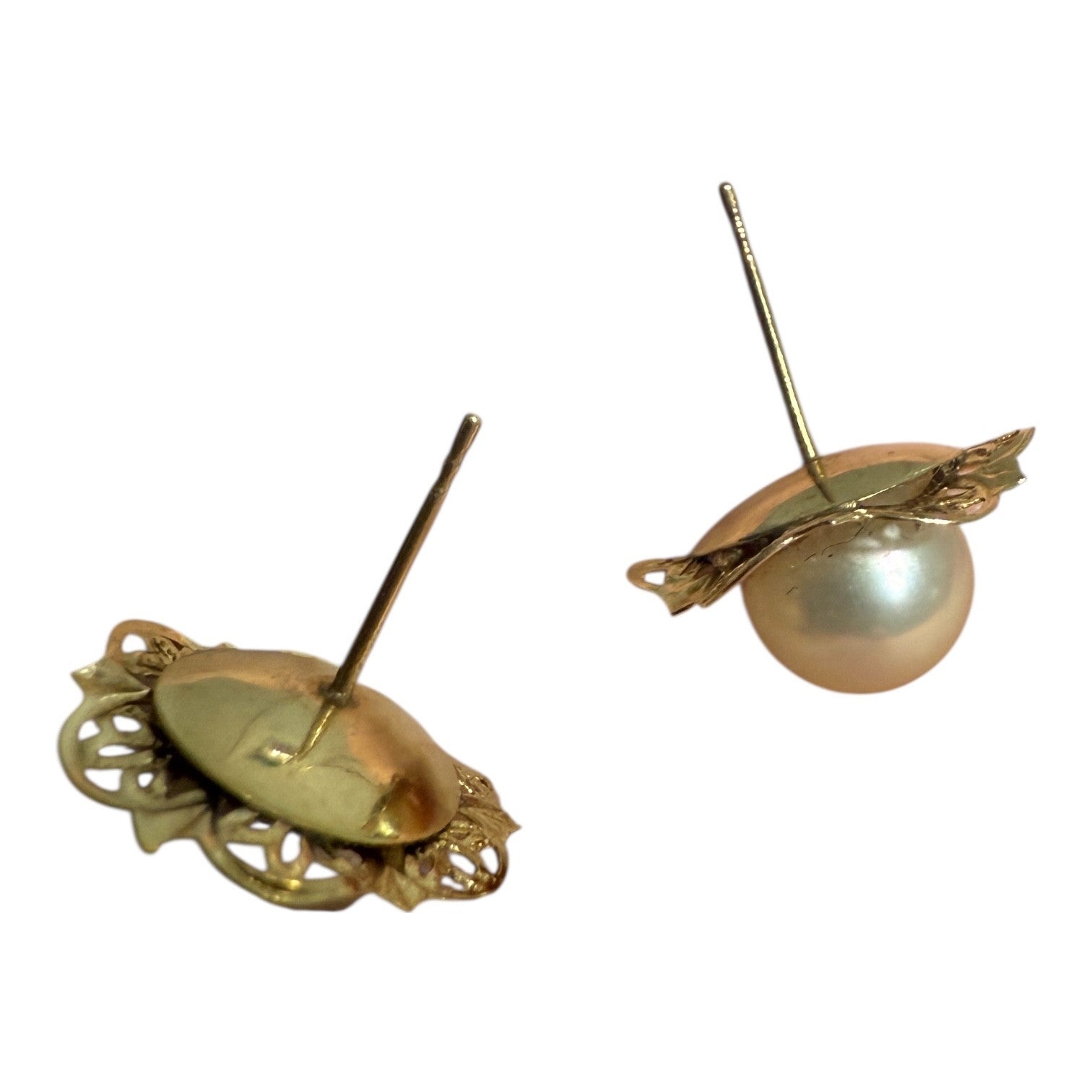 Back view of vintage 14K gold pearl stud earrings showing floral filigree backs and posts on a white background