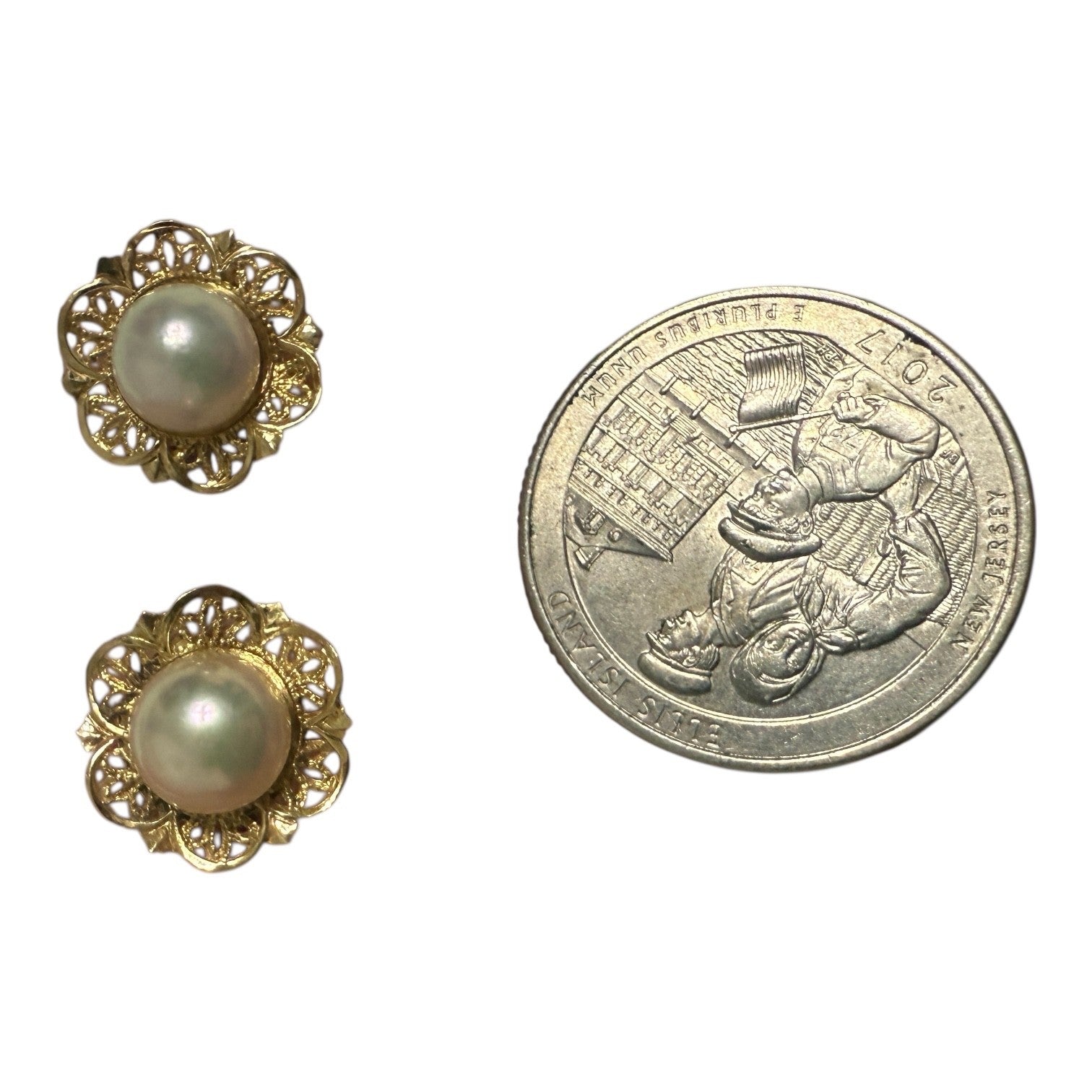 Back view of vintage 14k gold pearl stud earrings showing butterfly backs and 14k stamp on a white background