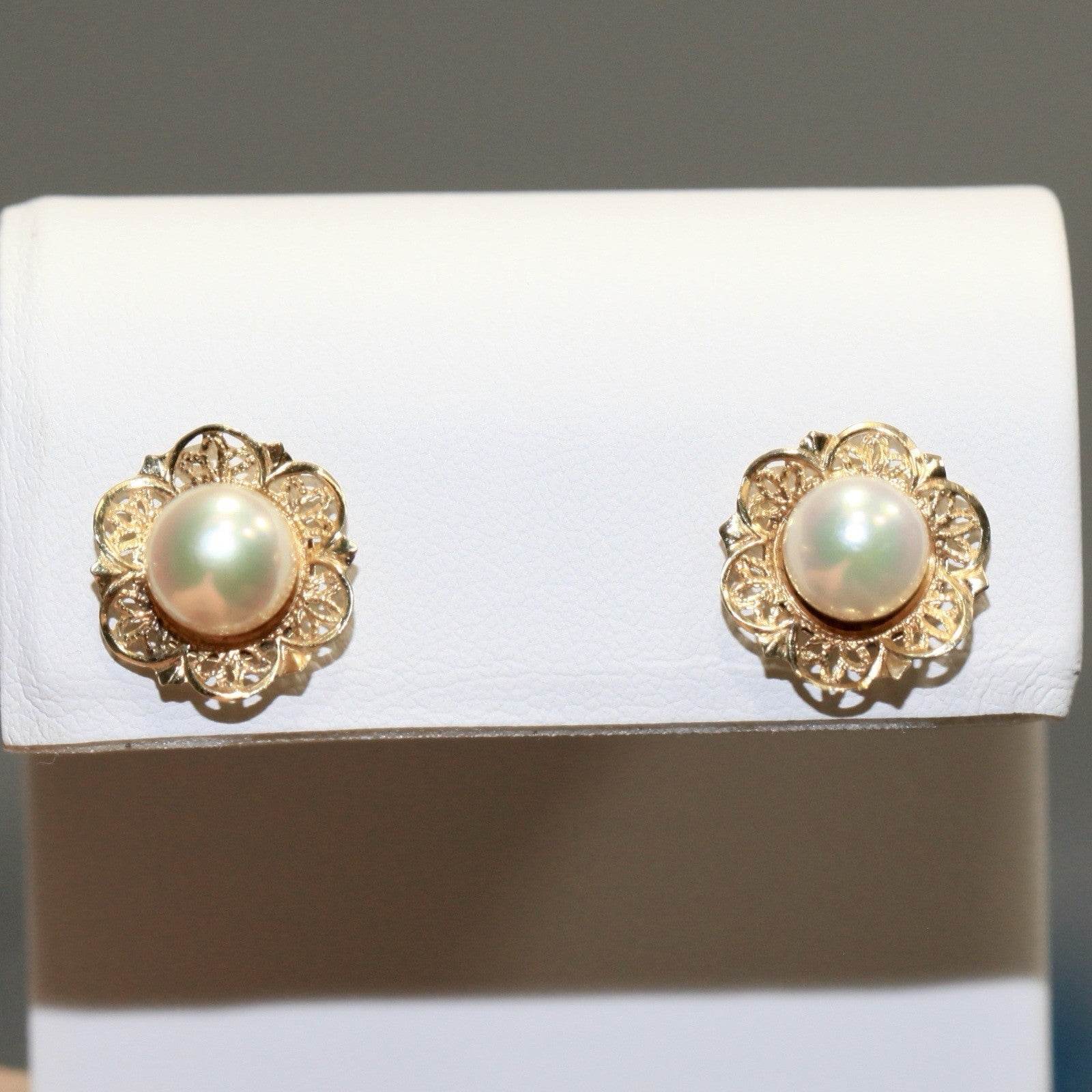 Vintage 1960s 14k gold filigree pearl flower stud earrings on white stand