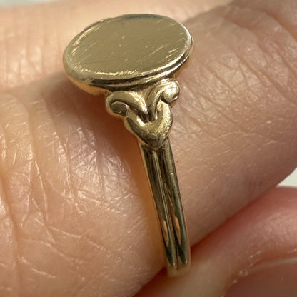 Side profile of antique Edwardian 14K gold oval signet ring showing hand-finished shoulder details