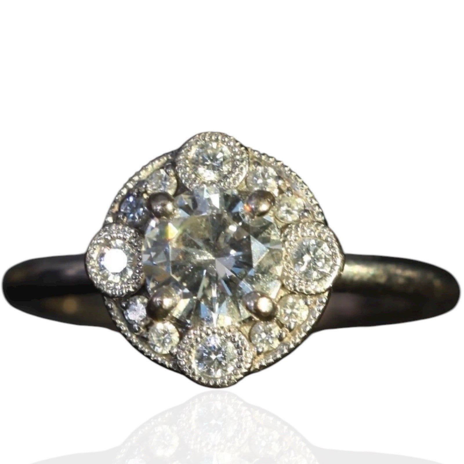 Laurence Bruyninckx 18K white gold diamond halo ring with round center stone on a white background