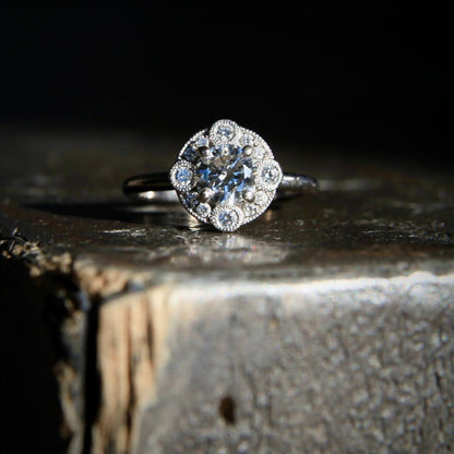 Laurence Bruyninckx 18K white gold diamond halo ring on textured stone surface