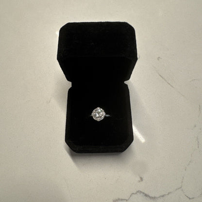 18K white gold diamond ring presented in a black velvet ring box on a light stone surface