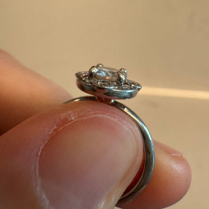 Side profile view of the 18K white gold diamond ring showing the raised setting