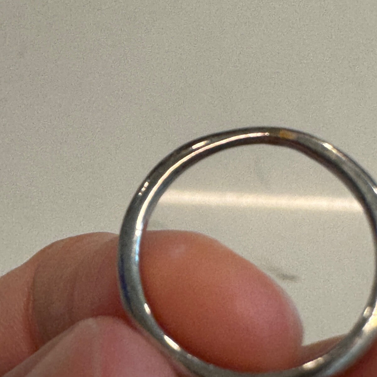 Back view of an 18K white gold diamond ring band showing smooth shank and condition