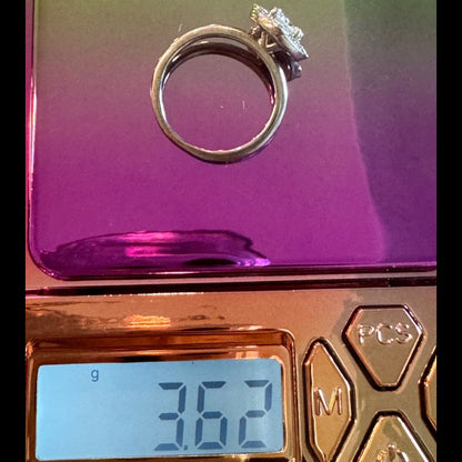 Laurence Bruyninckx 18K white gold diamond halo ring shown on digital scale weighing 3.62 grams