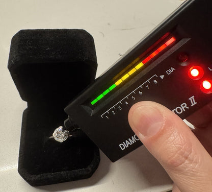 Diamond halo ring being tested with a professional diamond tester