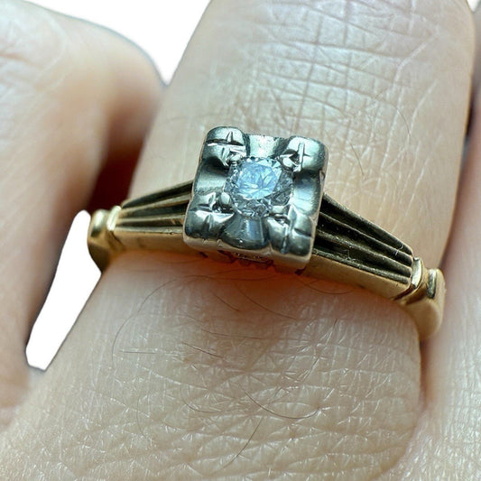 Close-up of vintage 14K gold diamond illusion head ring showing diamond detail and setting on finger