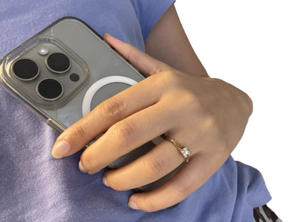 Hand holding a phone while wearing a vintage 14K gold diamond illusion head ring, lifestyle shot on white background
