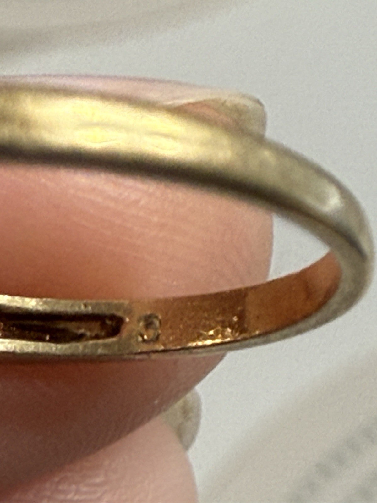 Close-up of the inside band of a vintage 14K gold diamond ring showing maker’s mark
