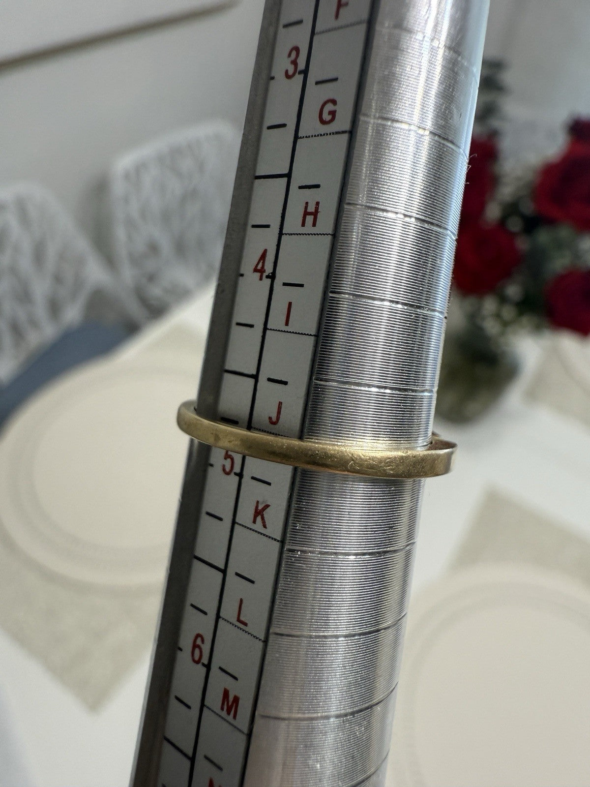 Vintage 14K gold diamond ring shown on a ring mandrel, size 4.75