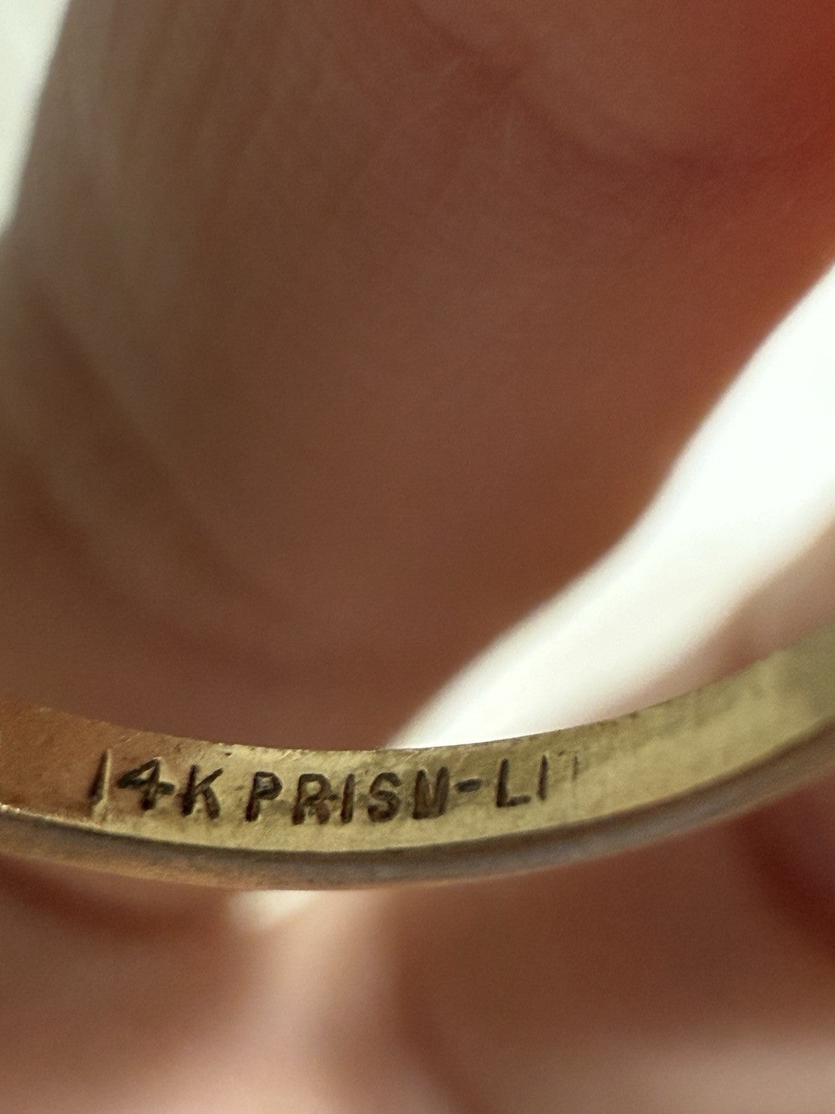 Close-up of vintage 14K PRISM-LI hallmark stamp inside a gold diamond ring band